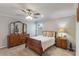 Bright and spacious main bedroom with neutral walls, ceiling fan, and a closet for ample storage at 490 Pentas Ln, Haines City, FL 33844