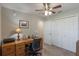 Home office with wooden desk, ceiling fan, and closet for convenient work-from-home setup at 490 Pentas Ln, Haines City, FL 33844