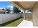 This covered patio overlooks a backyard with a white privacy fence at 490 Pentas Ln, Haines City, FL 33844