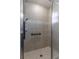 Modern shower featuring a hand-held sprayer, a built-in seat, and neutral ceramic tiling at 490 Pentas Ln, Haines City, FL 33844