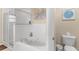 Bathroom featuring a soaking tub, glass-enclosed shower, neutral tones, and a tile floor at 5300 S Atlantic Ave # 5507, New Smyrna Beach, FL 32169