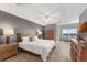 Spacious bedroom features a sitting area, tray ceilings, ceiling fan, and en-suite bath at 5300 S Atlantic Ave # 5507, New Smyrna Beach, FL 32169