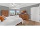 Bright bedroom features a queen size bed, wooden furniture, and a large television at 5300 S Atlantic Ave # 5507, New Smyrna Beach, FL 32169