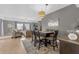 Open-concept dining area featuring a woven chandelier, gray walls and views into the living room at 5300 S Atlantic Ave # 5507, New Smyrna Beach, FL 32169