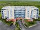 Aerial view of condo complex showing entryway, parking and landscaping at 5300 S Atlantic Ave # 5507, New Smyrna Beach, FL 32169