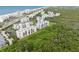 Aerial view of the beach side condos, parking lots and greenery at 5300 S Atlantic Ave # 5507, New Smyrna Beach, FL 32169
