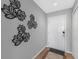 Hallway with tile floor, decorative leaves and white door at 5300 S Atlantic Ave # 5507, New Smyrna Beach, FL 32169