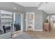 Bright living room with a sliding glass door to balcony and an open doorway to the bathroom at 5300 S Atlantic Ave # 5507, New Smyrna Beach, FL 32169