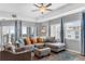 Bright living room featuring a comfortable sectional sofa, and sliding glass doors to the balcony at 5300 S Atlantic Ave # 5507, New Smyrna Beach, FL 32169