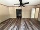 Spacious bedroom boasts wood-look flooring, neutral walls, and a doorway to the ensuite bathroom at 56048 Blue Creek Rd, Astor, FL 32102