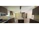 Features stainless steel appliances, a central island, and dark wood cabinets that offer plenty of storage at 56048 Blue Creek Rd, Astor, FL 32102