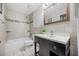 Well-lit bathroom featuring a modern vanity, a framed mirror, and a tiled shower and tub combo at 5672 Parkview Lake Dr, Orlando, FL 32821