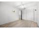 Bright bedroom features wood-look floors, a ceiling fan, and a closet with paneled doors at 5672 Parkview Lake Dr, Orlando, FL 32821