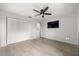 Spacious bedroom featuring hardwood floors, a ceiling fan, a TV and a closet at 5672 Parkview Lake Dr, Orlando, FL 32821