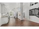 Open-concept kitchen featuring white cabinetry, a center island, modern appliances, and beautiful hardwood floors at 5672 Parkview Lake Dr, Orlando, FL 32821