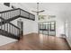 Bright living room featuring wood floors, a staircase, and glass sliding doors at 5672 Parkview Lake Dr, Orlando, FL 32821