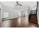 Open floor plan living room featuring hardwood floors, large windows, and stairs leading to the second floor at 5672 Parkview Lake Dr, Orlando, FL 32821