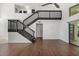Bright living room featuring wood floors, a staircase, and glass sliding doors at 5672 Parkview Lake Dr, Orlando, FL 32821