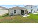Backyard featuring a patio with outdoor seating, a shaded swing, and a green lawn at 6834 Wilson Hammock Ave, Groveland, FL 34736