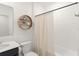 Cozy bathroom with a bathtub and shower, decorative wooden shelf, and a modern vanity at 6834 Wilson Hammock Ave, Groveland, FL 34736