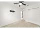 Bedroom featuring neutral carpet, a ceiling fan, closet, and wall mount for TV at 6834 Wilson Hammock Ave, Groveland, FL 34736