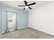 Bedroom with a blue accent wall, a ceiling fan, neutral carpet, and a window with blinds at 6834 Wilson Hammock Ave, Groveland, FL 34736