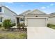 Charming single-story home featuring a two-car garage and well-maintained landscaping at 6834 Wilson Hammock Ave, Groveland, FL 34736