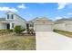 Charming single-Gathering home with a well-manicured front lawn and a two-car garage at 6834 Wilson Hammock Ave, Groveland, FL 34736