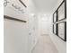 Bright hallway with tile floors, white walls, and modern black decorative mirrors at 6834 Wilson Hammock Ave, Groveland, FL 34736