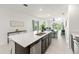 Open kitchen featuring an island with a sink and a view of the living area at 6834 Wilson Hammock Ave, Groveland, FL 34736
