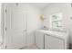 A bright and clean laundry room with a modern washer and dryer at 6834 Wilson Hammock Ave, Groveland, FL 34736