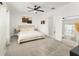 Bright and airy main bedroom with neutral tones, a comfortable king bed, and a view of a mirror and other furniture at 6834 Wilson Hammock Ave, Groveland, FL 34736