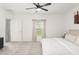 Comfortable main bedroom featuring plush carpeting, a ceiling fan, and a window with natural light at 6834 Wilson Hammock Ave, Groveland, FL 34736