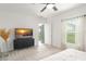 Bright main bedroom with neutral carpet and furnishings; window and access to backyard view at 6834 Wilson Hammock Ave, Groveland, FL 34736