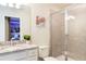 Bathroom featuring granite countertop, toilet, and glass-enclosed shower at 7224 Oakmoss Loop, Davenport, FL 33837