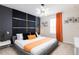 Modern bedroom with stylish accent wall, decorative lighting and artwork at 7224 Oakmoss Loop, Davenport, FL 33837