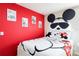 Bedroom with themed decorations including wall art and Mickey Mouse bedding at 7224 Oakmoss Loop, Davenport, FL 33837