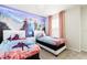 Bright bedroom with two beds and a large mural of the Frozen characters at 7224 Oakmoss Loop, Davenport, FL 33837