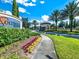 Inviting community entrance with lush landscaping, featuring a colorful 'Solterra Resort' sign at 7224 Oakmoss Loop, Davenport, FL 33837