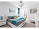 Bright main bedroom featuring a Queen bed, stylish linens, and modern decor at 7224 Oakmoss Loop, Davenport, FL 33837