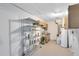Large basement with utility sink, storage shelves, and water heater at 7249 Abbey Ln, Winter Park, FL 32792