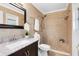 Beautiful bathroom featuring tile shower, dark-stained vanity, and large mirror at 7249 Abbey Ln, Winter Park, FL 32792