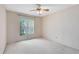 Bedroom with natural light from large window. Features a ceiling fan and carpet flooring at 7249 Abbey Ln, Winter Park, FL 32792
