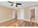 Spacious bedroom featuring hardwood floors, ceiling fan, and ensuite bathroom at 7249 Abbey Ln, Winter Park, FL 32792