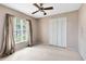 Bedroom featuring a ceiling fan, window with natural light, and closet with louvered doors at 7249 Abbey Ln, Winter Park, FL 32792