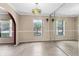 Dining room features tile floors, windows, and large mirror adding depth to the space at 7249 Abbey Ln, Winter Park, FL 32792