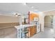 The kitchen is connected to the main living space and includes an island with breakfast bar seating at 7249 Abbey Ln, Winter Park, FL 32792
