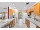 Well-lit kitchen featuring light wood cabinetry, an open design, and modern appliances at 7249 Abbey Ln, Winter Park, FL 32792
