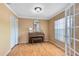 Living Room with hardwood floors. View to front yard through french doors at 7249 Abbey Ln, Winter Park, FL 32792