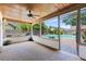 A screened patio with a wooden ceiling, fan, and views of the backyard pool creates a relaxing outdoor space at 7249 Abbey Ln, Winter Park, FL 32792